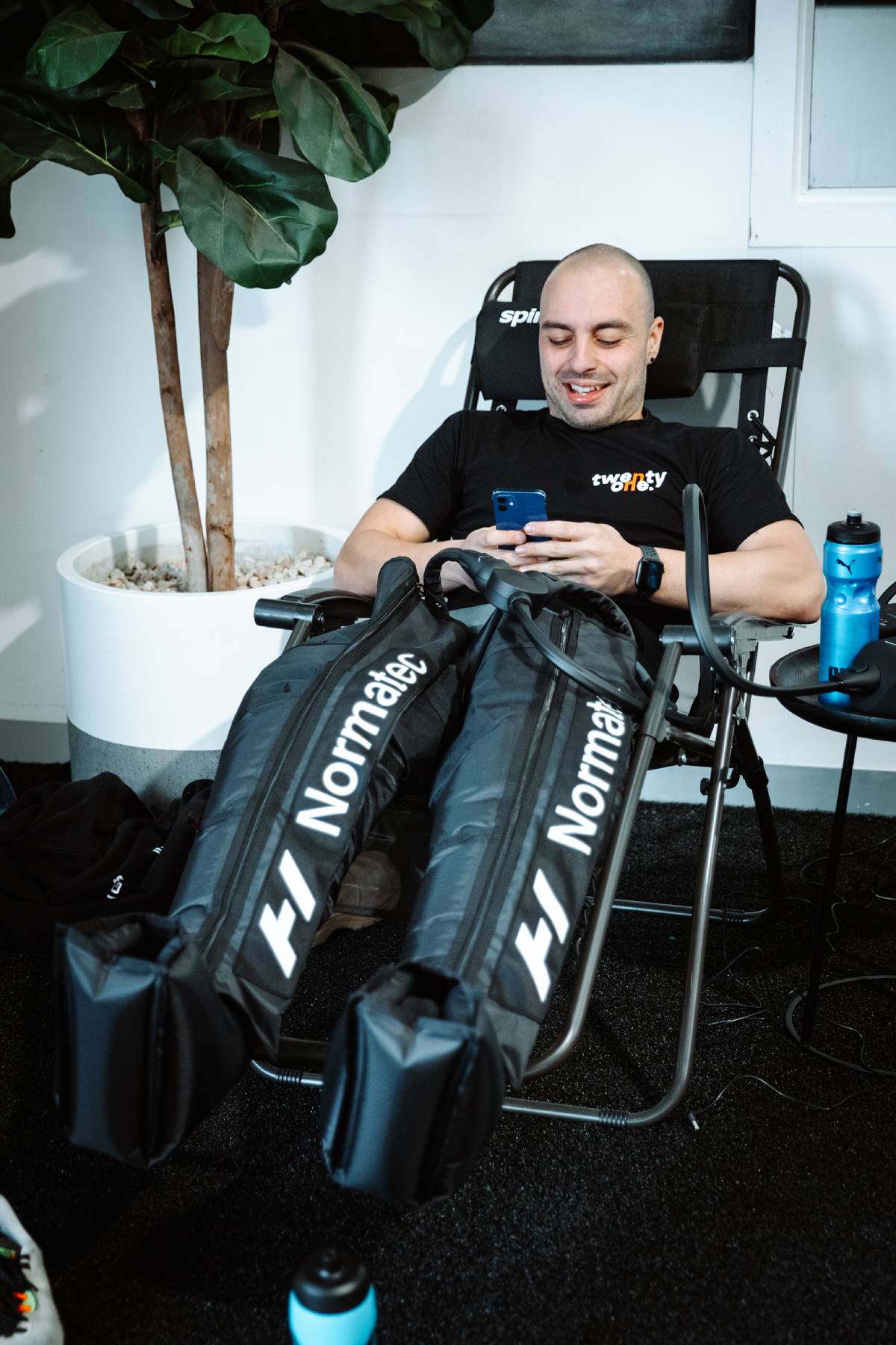 man wearing recovery boots after workout at twenty one gym in airport west