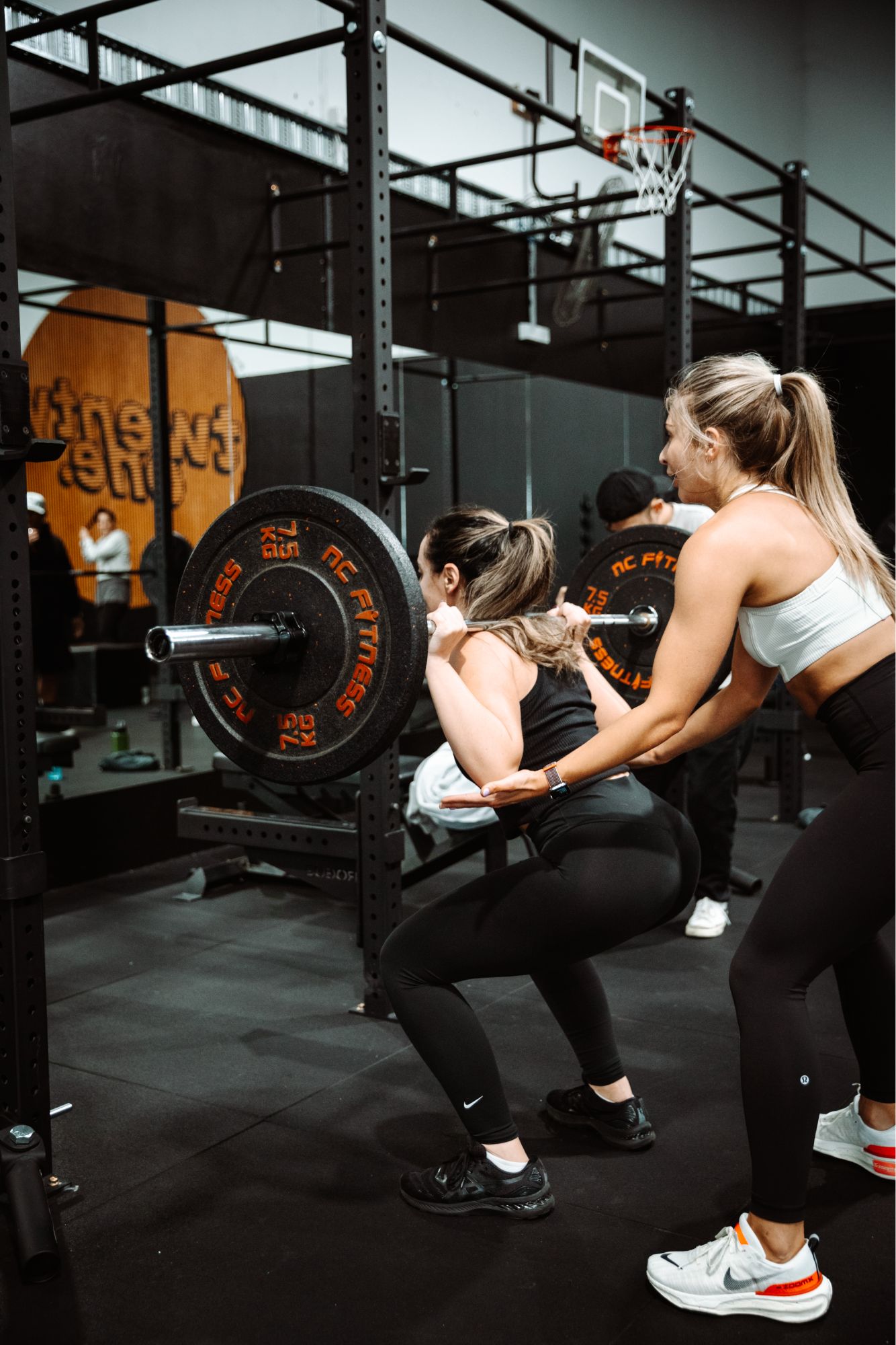 lady squatting in gym class build twenty one training