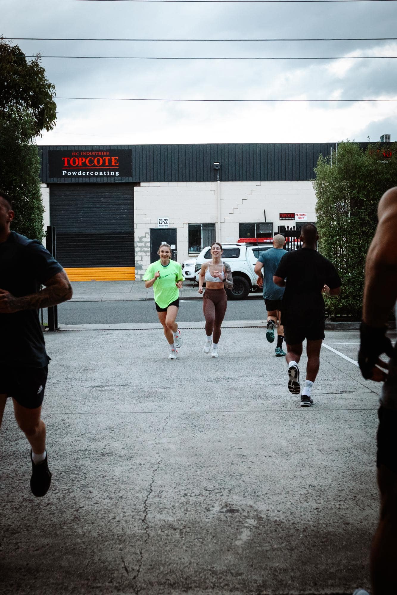 Ladies running outside on driveway of Twenty One Training gym in airport west