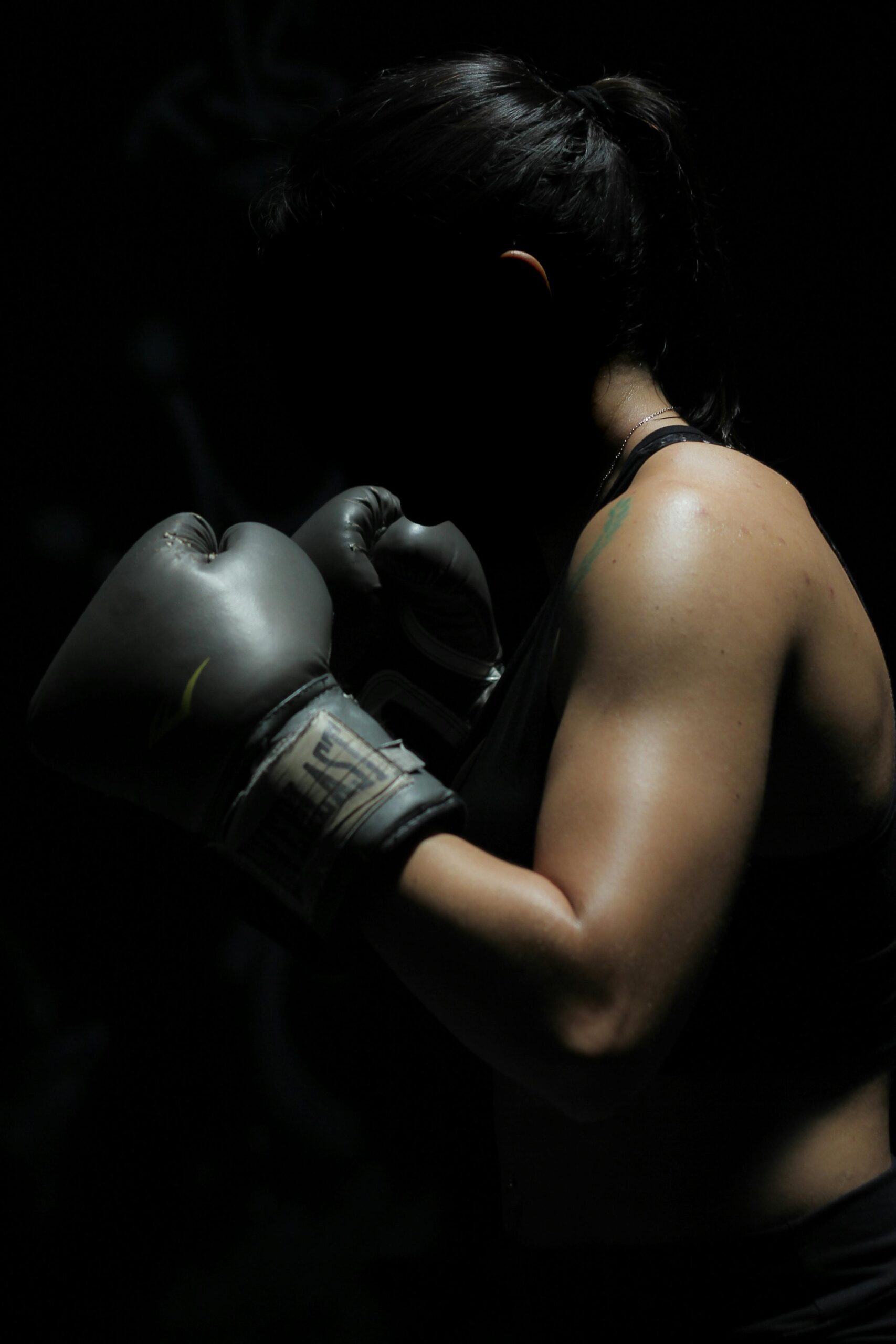 woman wearing black boxing glove